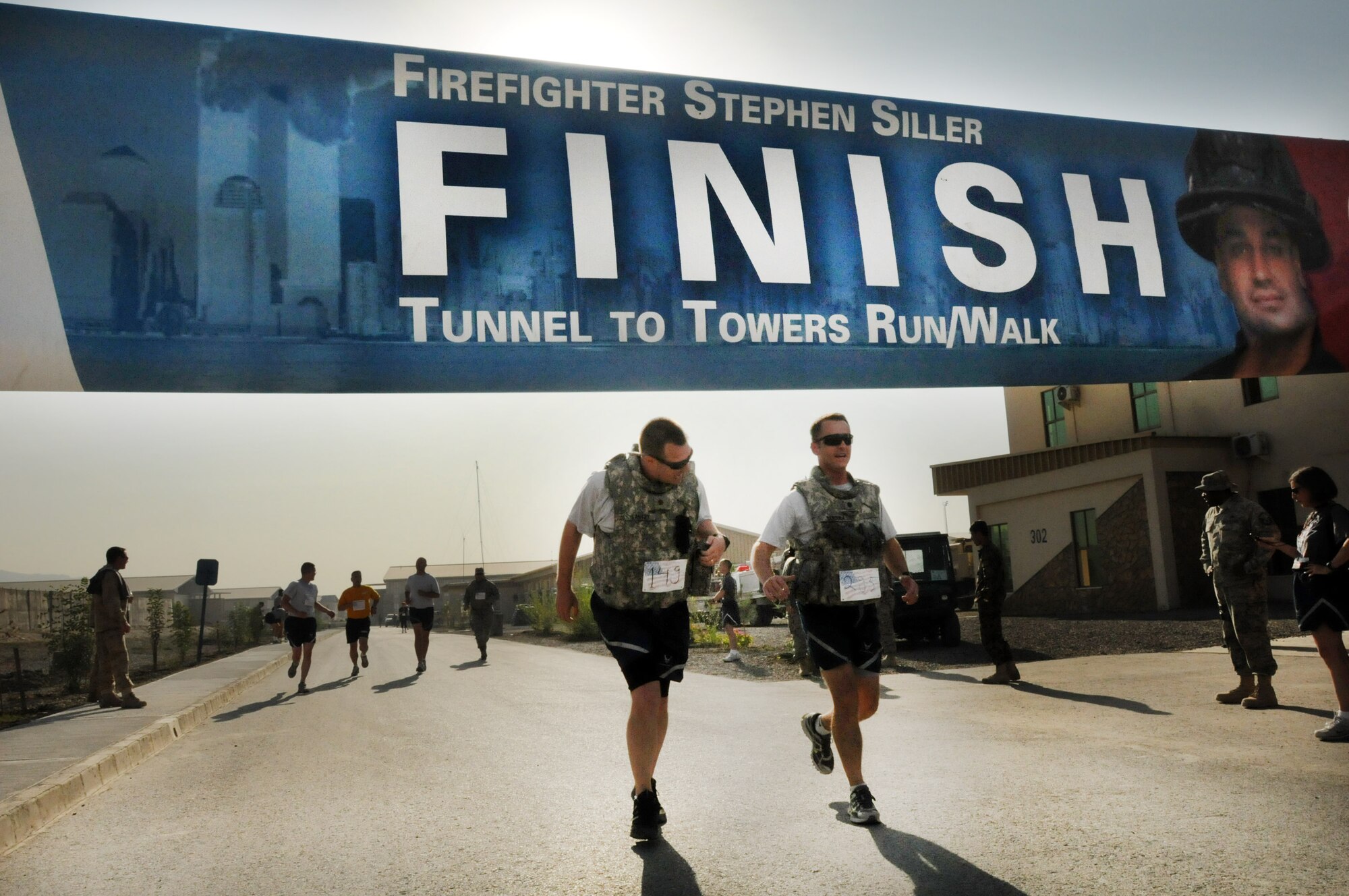 100924-N-6031Q-006 KABUL, Afghanistan - NATO Air Training Command- Afghanistan personnel alongside NATO and civilian partners participate in the "Tunnel to Towers run/walk race on Sep. 24, 2010. The race was held on the International Security Assistance Force and Afghan Air Force base in Kabul, Afghanistan. The race is to commemorate the arduous run made by New York City Firefighter Stephen Siller, who during the events of 9/11 picked up his gear weighing 75 pounds and ran to the twin towers nearly three miles away and perished alongside his fellow firefighters in the attempt to save lives. After the race a piece of steel was placed in a memorial on the grounds of the AAF base where it will stay until the last American leaves Afghanistan. (US Navy photo by Mass Communication Specialist 2nd Class David Quillen/ RELEASED).