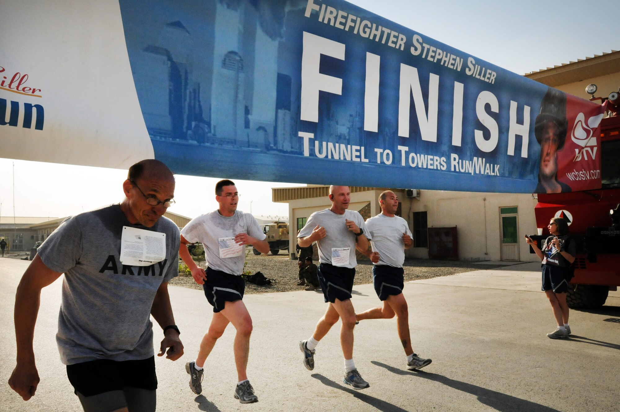 100924-N-6031Q-005 KABUL, Afghanistan - NATO Air Training Command- Afghanistan personnel alongside NATO and civilian partners participate in the "Tunnel to Towers run/walk race on Sep. 24, 2010. The race was held on the International Security Assistance Force and Afghan Air Force base in Kabul, Afghanistan. The race is to commemorate the arduous run made by New York City Firefighter Stephen Siller, who during the events of 9/11 picked up his gear weighing 75 pounds and ran to the twin towers nearly three miles away and perished alongside his fellow firefighters in the attempt to save lives. After the race a piece of steel was placed in a memorial on the grounds of the AAF base where it will stay until the last American leaves Afghanistan. (US Navy photo by Mass Communication Specialist 2nd Class David Quillen/ RELEASED).