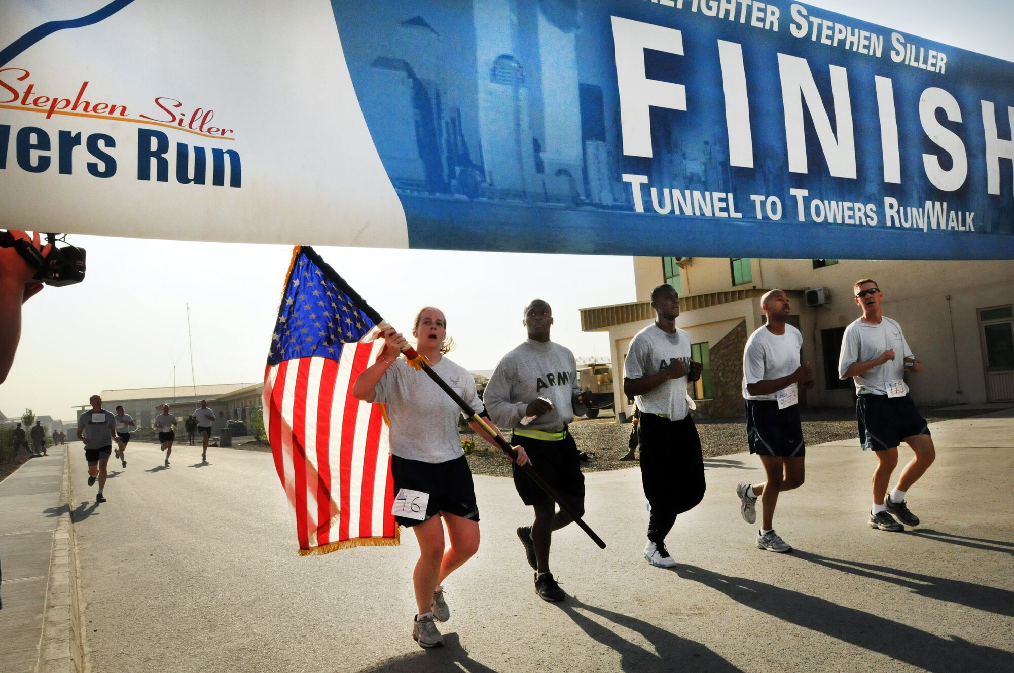 100924-N-6031Q-004 KABUL, Afghanistan - NATO Air Training Command- Afghanistan personnel alongside NATO and civilian partners participate in the "Tunnel to Towers run/walk race on Sep. 24, 2010. The race was held on the International Security Assistance Force and Afghan Air Force base in Kabul, Afghanistan. The race is to commemorate the arduous run made by New York City Firefighter Stephen Siller, who during the events of 9/11 picked up his gear weighing 75 pounds and ran to the twin towers nearly three miles away and perished alongside his fellow firefighters in the attempt to save lives. After the race a piece of steel was placed in a memorial on the grounds of the AAF base where it will stay until the last American leaves Afghanistan. (US Navy photo by Mass Communication Specialist 2nd Class David Quillen/ RELEASED).