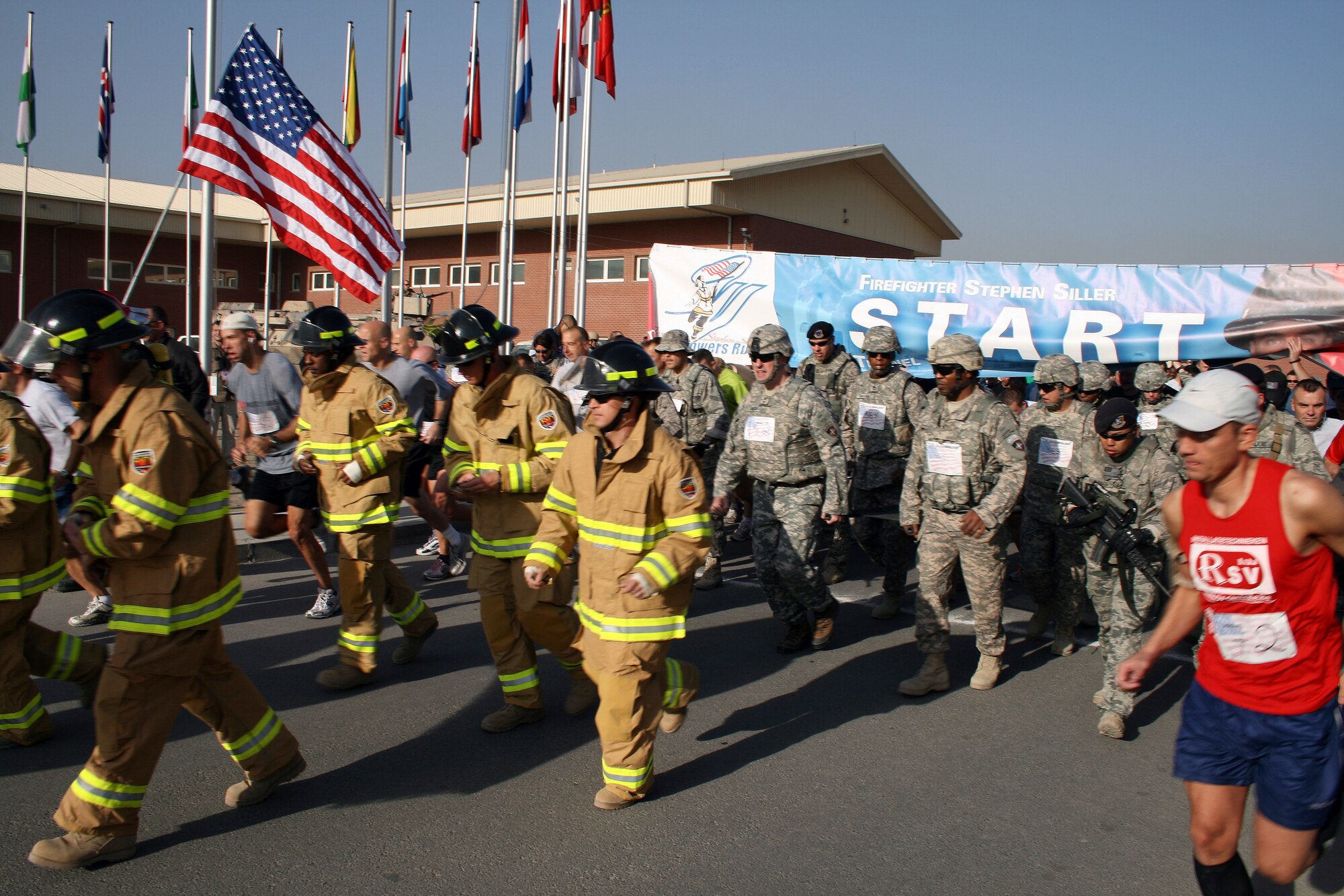 100924-F-8476C-001 KABUL, Afghanistan - NATO Air Training Command- Afghanistan personnel alongside NATO and civilian partners participate in the "Tunnel to Towers run/walk race on Sep. 24, 2010. The race was held on the International Security Assistance Force and Afghan Air Force base in Kabul, Afghanistan. The race is to commemorate the arduous run made by New York City Firefighter Stephen Siller, who during the events of 9/11 picked up his gear weighing 75 pounds and ran to the twin towers nearly three miles away and perished alongside his fellow firefighters in the attempt to save lives. After the race a piece of steel was placed in a memorial on the grounds of the AAF base where it will stay until the last American leaves Afghanistan. (US Air Force photo by Capt. Israel Camacho/ RELEASED).