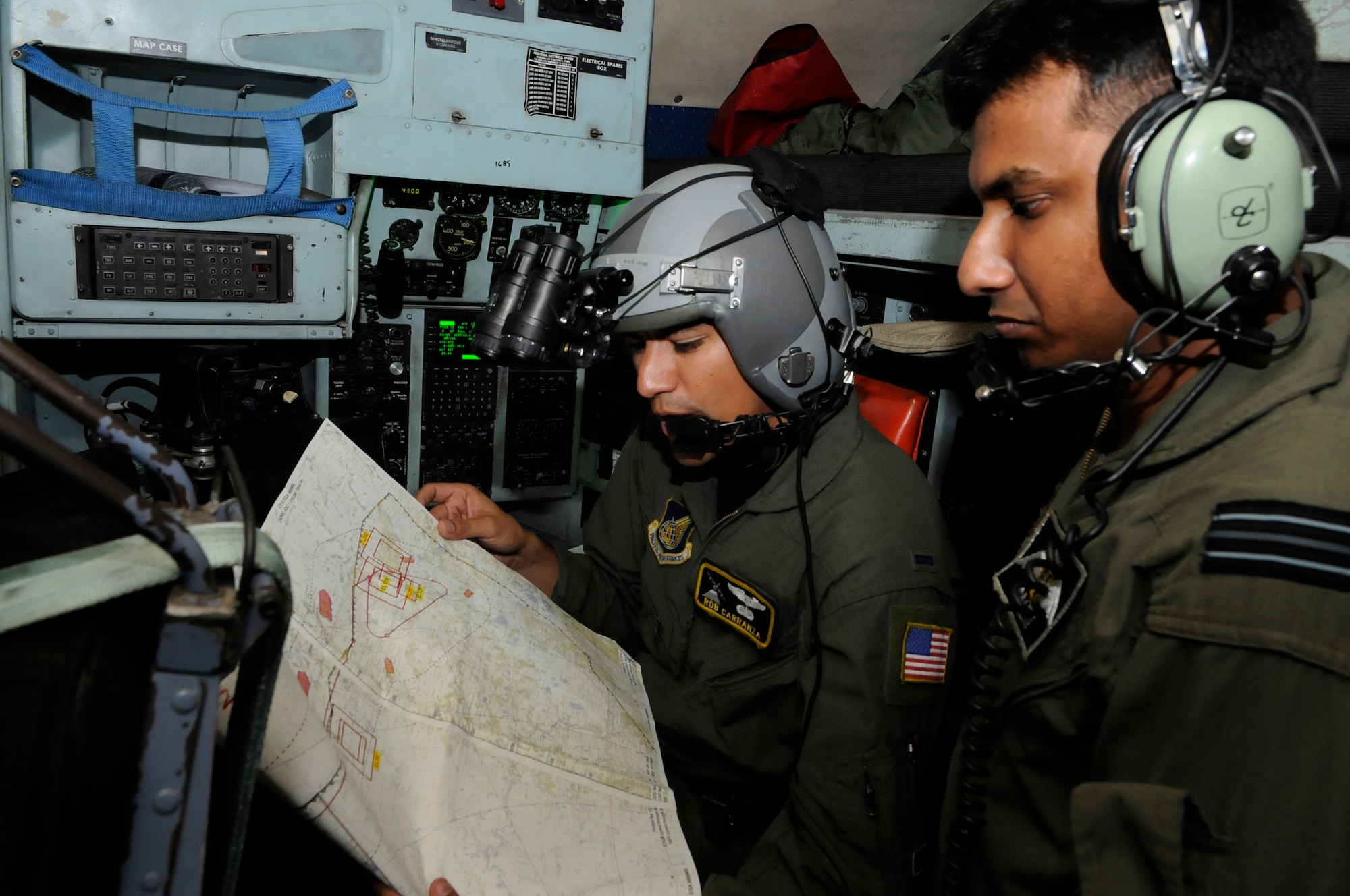 KURMITOLA AIR BASE, BANGLADESH - First Lt. Robert Carranza, a navigator with

the 36th Airlift Squadron, goes over route points with Bangladesh Flt. Lt.

Salem, a co-pilot, during a flight to Sylhet, Bangladesh, during exercise

Cope South 10, Sept. 22, 2010. The bilateral exercise's subject matter

expert exchanges in maintenance, operations and rigging disciplines

strengthen the strong and growing partnership between the United States and

Bangladesh. Two C-130s from Yokota Air Base, Japan, and an AN-32 from

Kurmitola Air Base participated in Cope South 10.(U.S, Air Force photo by Master Sgt. Jeffery Loftlin)
