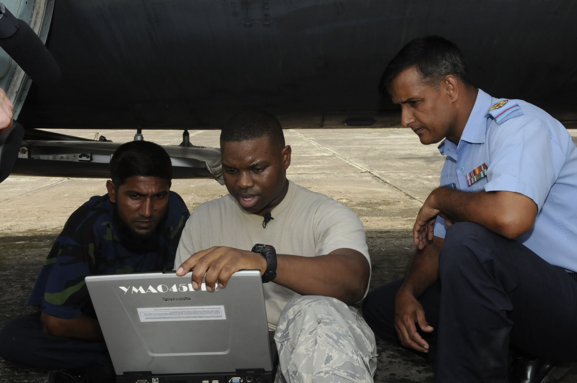 KURMITOLA AIR BASE, BANGLADESH - Staff Sgt. Christopher Smith, 374th

Aircraft Maintenance Squadron, helps Bangladesh Air Force Sgt. Halim and

Warrant Officer Malek find a solution to a circuit breaker problem on their

C-130 Hercules aircraft during exercise Cope South 10, Sept. 22, 2010. The

bilateral exercise's subject matter expert exchanges in maintenance,

operations and rigging disciplines strengthen the strong and growing

partnership between the United States and Bangladesh. Two C-130s from Yokota

Air Base, Japan, and an AN-32 from Kurmitola Air Base particpated in Cope

South 10.(U.S, Air Force photo by Master Sgt. Jeffery Loftlin)
