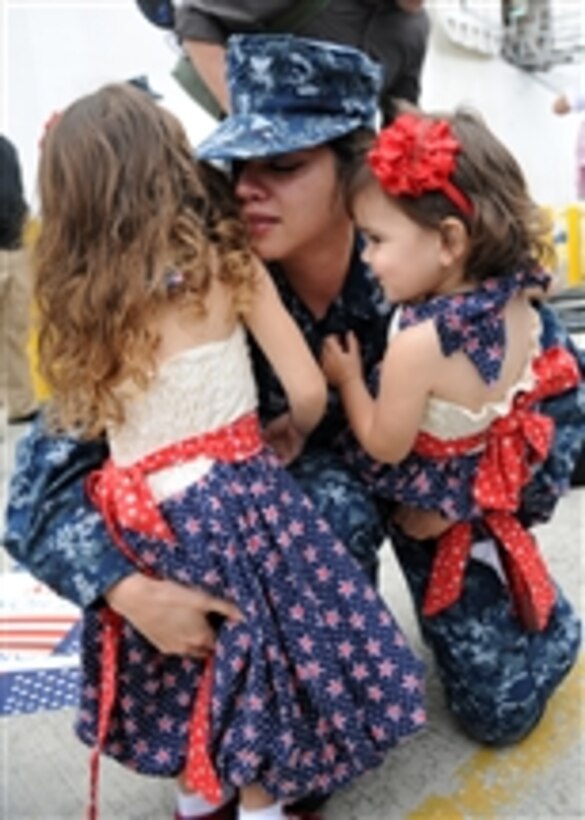 U.S. Navy Petty Officer 3rd Class Jerrilynn Sweat hugs her daughters during a homecoming ceremony in San Diego, Calif., for the Military Sealift Command hospital ship USNS Mercy (T-AH 19) on Sept. 21, 2010.  The Mercy returned to the area following its five-month deployment in support of Pacific Partnership 2010 contributing to medical and dental humanitarian assistance in Vietnam, Cambodia, Indonesia and Timor-Leste.  