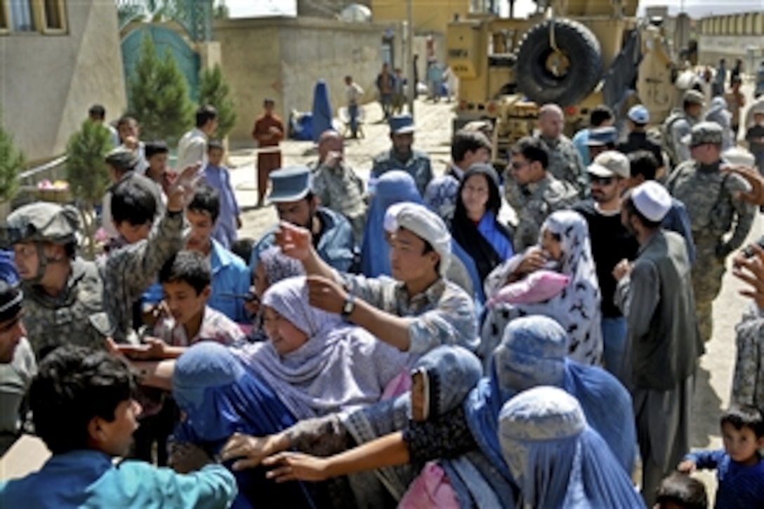 U.S. Army soldiers deliver food and supplies to families in the Dasht Barchi village of Kabul, Afghanistan, Sept. 23, 2010. The soldiers partnered with Afghan police to procure and deliver aid items to 150 needy families whose homes suffered extensive water damage during a flood. The soldiers are assigned to the 1st Battalion, 101st Field Artillery Regiment, Massachusetts National Guard.