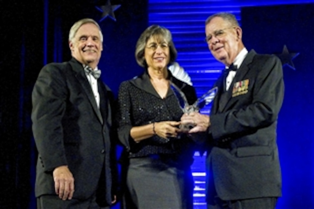 Robert Hale, left, under secretary of defense and chief financial officer, and Dennis McCarthy, right, assistant defense secretary for reserve affairs, present the Secretary of Defense Employer Support Freedom Award to Hawaii Gov. Linda Lingle on behalf of the Hawaii State Government in Washington, D.C., Sept. 23, 2010. The Freedom Award is the highest recognition the U.S. government gives to employers for their support of employees who serve in the National Guard and Reserve.