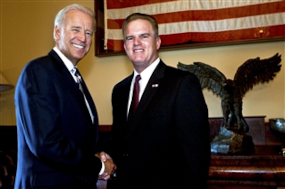 Vice President Joe Biden congratulates Bob Ravener Jr., executive vice president, Dollar General, for receiving the Secretary of Defense Employer Support Freedom Award in Washington, D.C., Sept. 23, 2010. The Freedom Award is the highest recognition the U.S. government gives to employers for their support of employees who serve in the National Guard and Reserve.