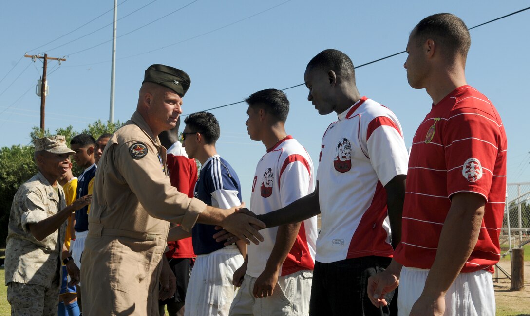 Col. Mark A. Werth, station commanding officer, and Sgt. Maj. Terry D. Stanford, shake hands with players from the West Coast Regional Soccer Tournament at the Marine Corps Air Station in Yuma, Ariz., Sept. 24, 2010. Two Yuma-based Marines were selected for All-Marine Soccer Team tryouts.