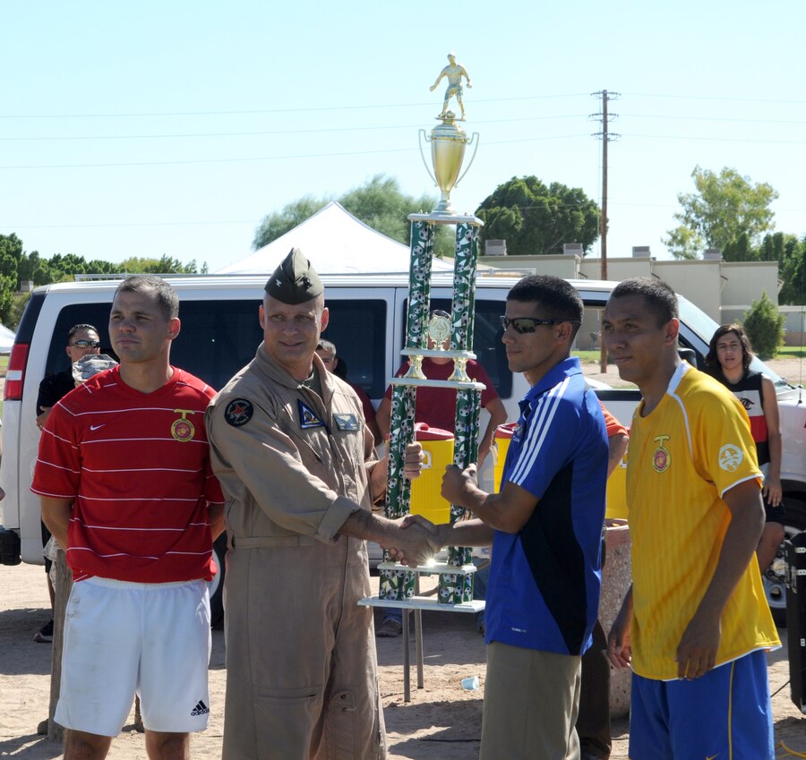 Col. Mark Werth, station commanding officer, congratulates the West Coast Regional Soccer Tournament champions from Marine Corps Base Camp Pendleton, who defeated the Marine Corps Air Ground Combat Center Twentynine Palms team in the championship game at the Marine Corps Air Station in Yuma, Ariz., Sept. 24, 2010. Two Yuma-based Marines were selected for All-Marine Soccer Team tryouts.