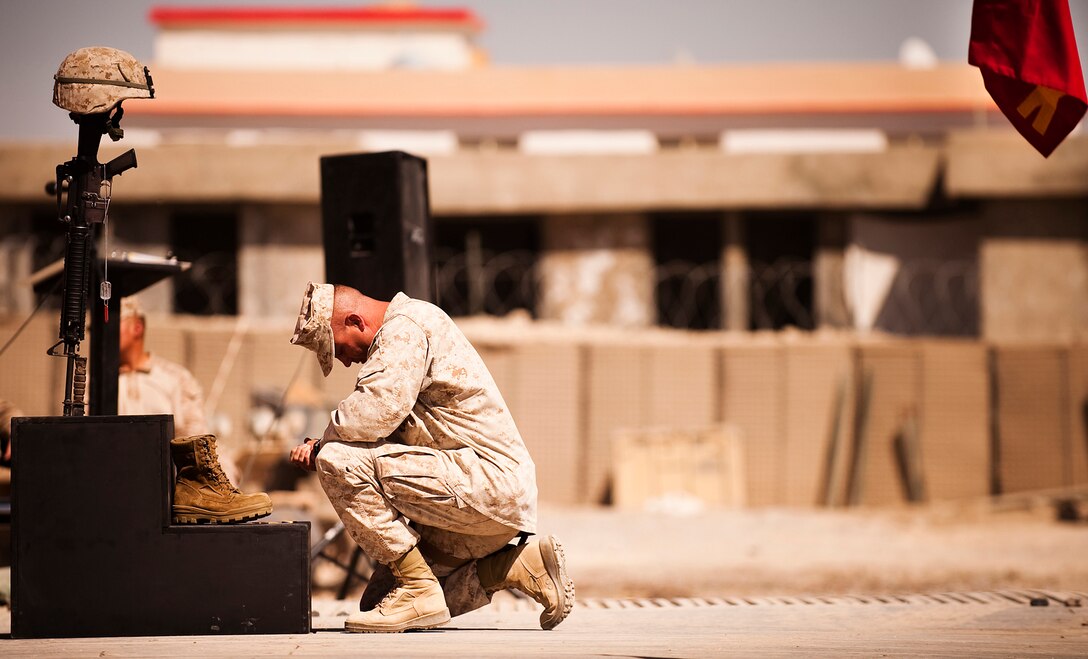 A Marine says goodbye to 1st Lt. Scott J. Fleming during his memorial service at Patrol Base Jaker, Afghanistan, Sept. 25, 2010. Fleming died supporting combat operations Sept. 17, 2010.