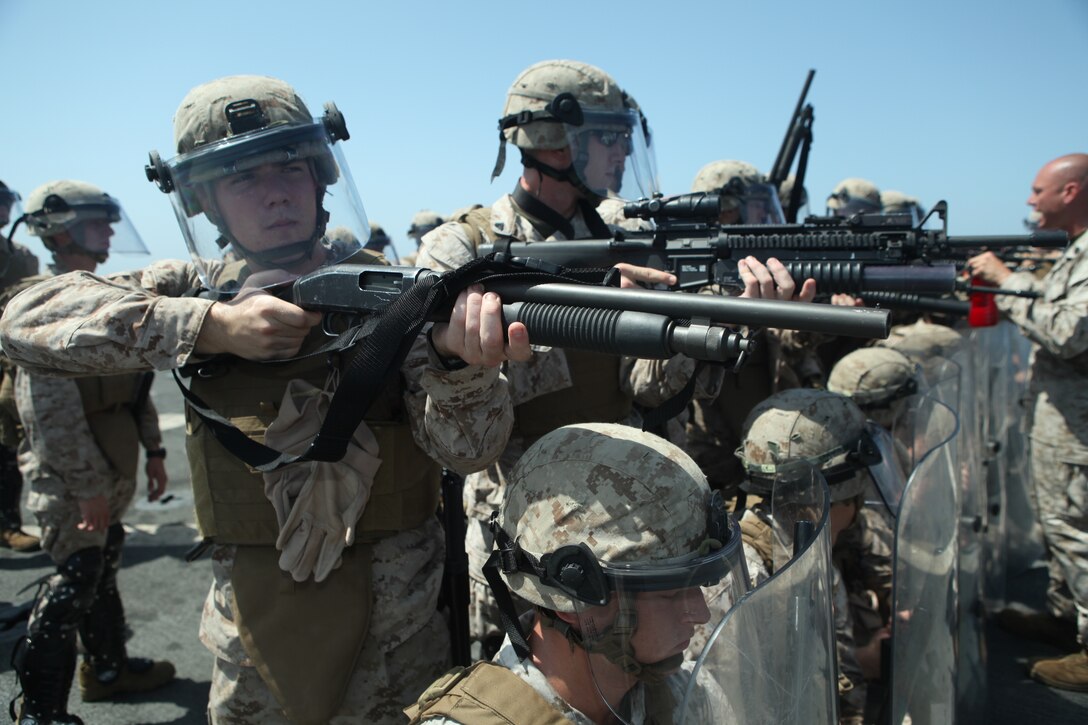 Marines with Company L, Battalion Landing Team 3/8, 26th Marine Expeditionary Unit, rehearse firing non-lethal  rounds on a simulated non-compliant crowd during non-lethal tactics training on the flight deck aboard USS Carter Hall in the U.S. Navy Fifth Fleet Area of Responsibility, Sept. 25, 2010. 26th MEU continues to support relief operations in Pakistan and is also serving as the theater reserve force as elements of the MEU conduct training and planned exercises.