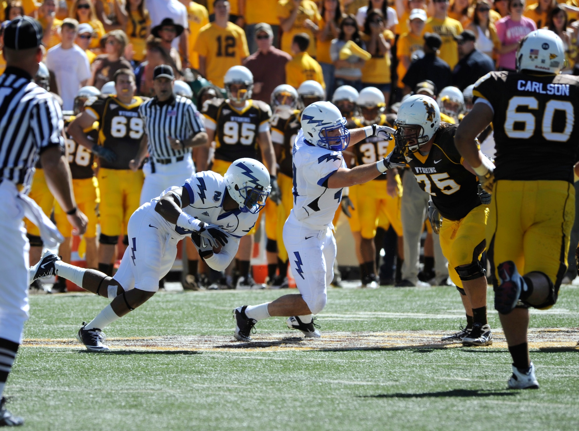 Falcons defensive back Jon Davis, left, returns an interception 23 yards during the Air Force-Wyoming match in Laramie, Wyo., Sept. 25, 2010. Davis, a Cincinnati native, also forced a fumble in the fourth quarter to crystalize Air Force's 20-14 win over the Cowboys. (U.S. Air Force photo/Dave Ahlschwede)
