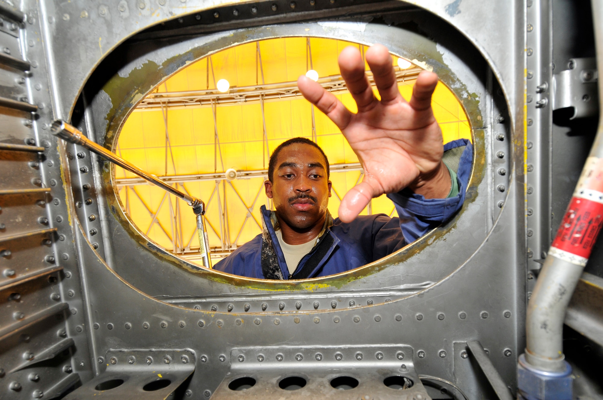 Senior Airmen Terrance Walton, 332nd Expeditionary Maintenance Squadron aircraft fuel systems technician, prepares to climb down into a C-130’s number one drive bay to torque check the main tank access door after a phase inspection Sept. 22, 2010, Joint Base Balad. The 332 EMXS Fuels Shop performs maintenance on F-16 Fighting Falcons and C-130 Hercules aircraft. Airman Walton is a native of Cuthbert, Ga., deployed from Little Rock Air Force Base, Ark. (Air Force photo/Staff Sgt. Phillip Butterfield)