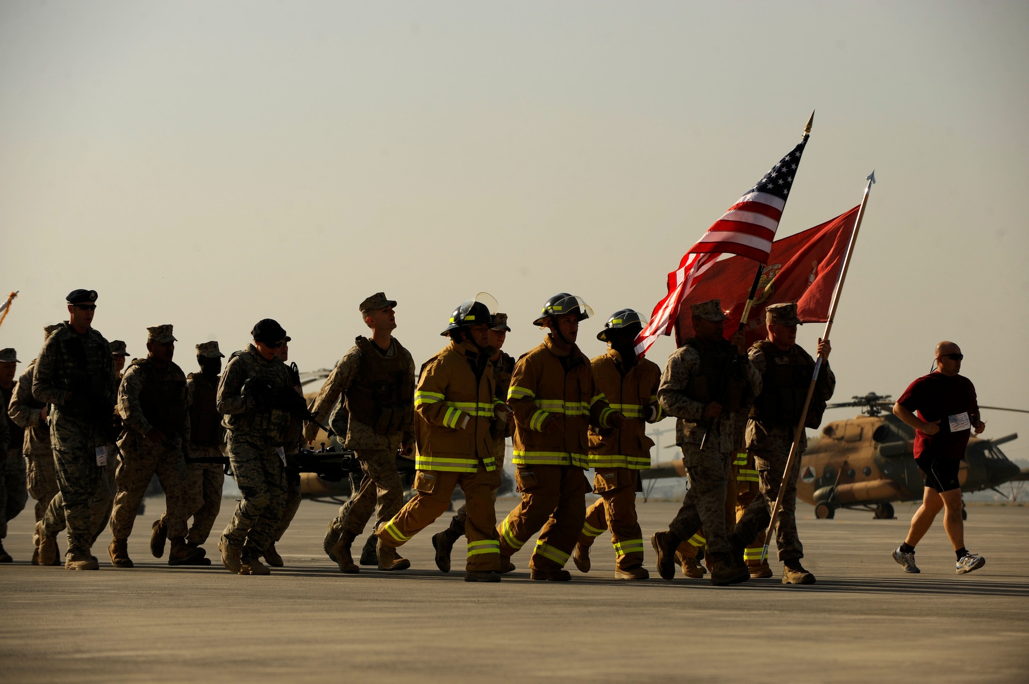 U.S. Marines carry a litter with a piece of wreckage from the World Trade Center in The Firefighter Stephen Siller Tunnel to Towers 5k Run/Walk at Kabul International Airport, Afghanistan, Sept. 24, 2010.  The litter was carried by U.S. Soldiers, Sailors, Marines and Airmen carried the litter on separate legs of the run.  (U.S. Air Force Photo/Staff Sgt. Eric Harris) (RELEASED)
