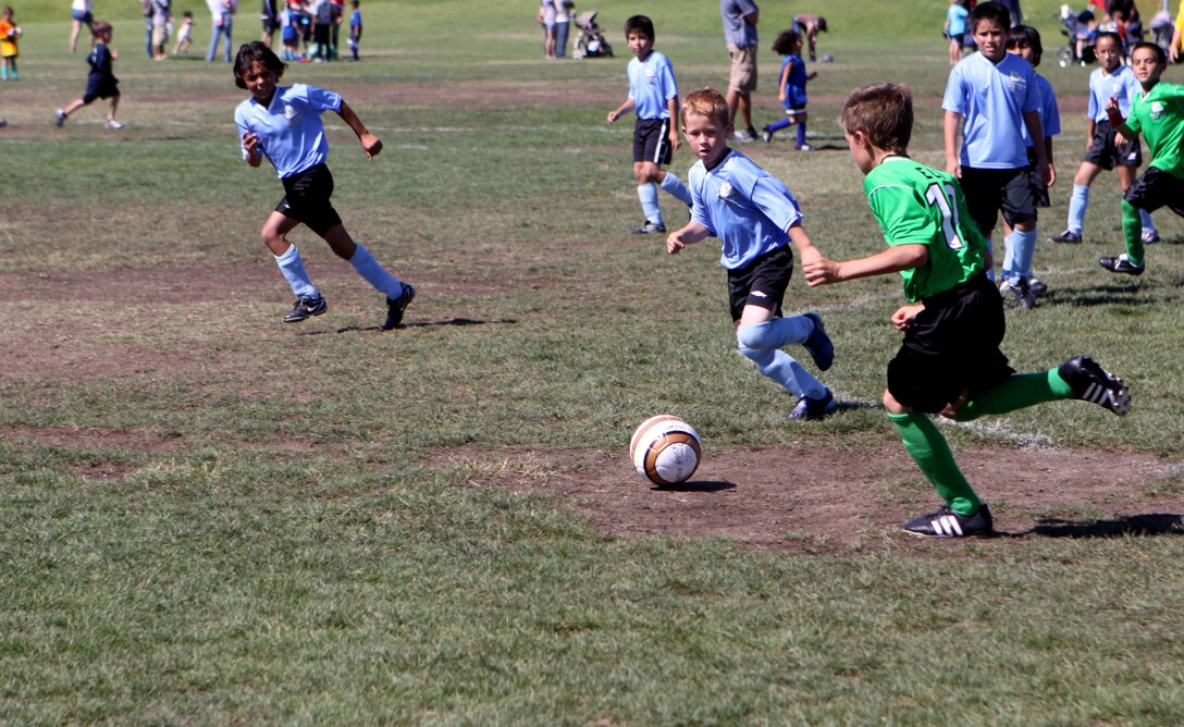 Children with the Camp Pendleton Youth Soccer program play one of their weekly games at Camp Pendleton’s 11 Area field, Sept. 25. The base’s Youth Soccer program is ran twice a year for children to learn the basic fundamentals of soccer.