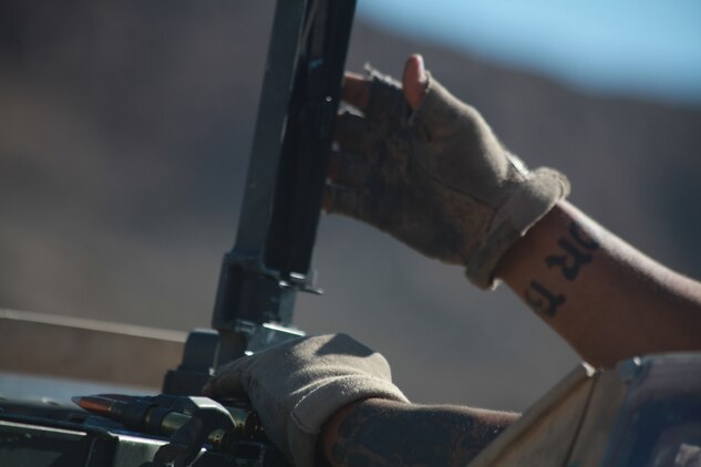 Corporal Maulalo Cortez, a rifleman from Company G, 2nd Battalion, 4th Marine Regiment, reloads his .50-caliber machine gun Sept. 27 after responding to enemy fire at Combat Center Range 220.  The Combat Center’s Advisor Training Group trains Marines like Cortez to get them prepared to train Afghan forces. (Photo by: Lance Cpl. M. C. Nerl)