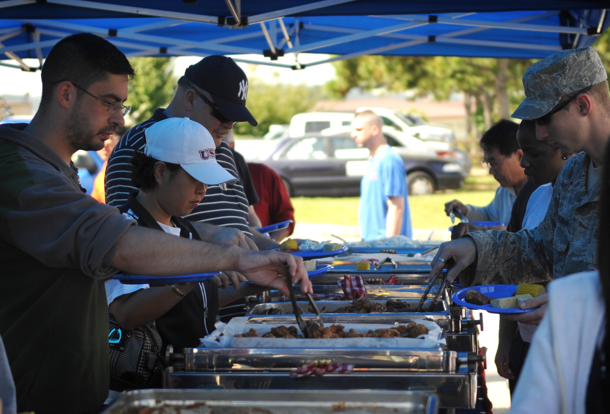 Event-goers load their plates with food during "Barbecue and Blues" at OsanAir Base Sept. 25.  The event included a rib contest and booth competitionin which competitors were judged on originality, theme, and appearance.Several performances and music were also part of the entertainment. (U.S.Air Force Photo/Senior Airman Evelyn Chavez)