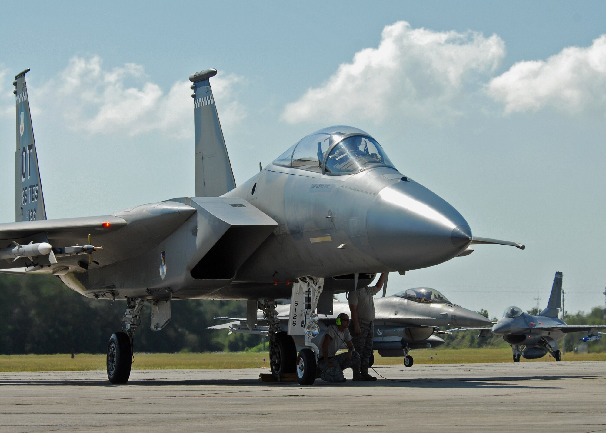 The 46th Test Wing maintainers beat the heat under a 53rd Wing F-15 prior to arming it for take off from Eglin Air Force Base, Fla.  More than 1,000 personnel of the 46th Maintenance Group are responsible for maintenance procedures for all of the 46th and 53rd aircraft located at Eglin.  (U.S. Air Force photo/Samuel King Jr.) 