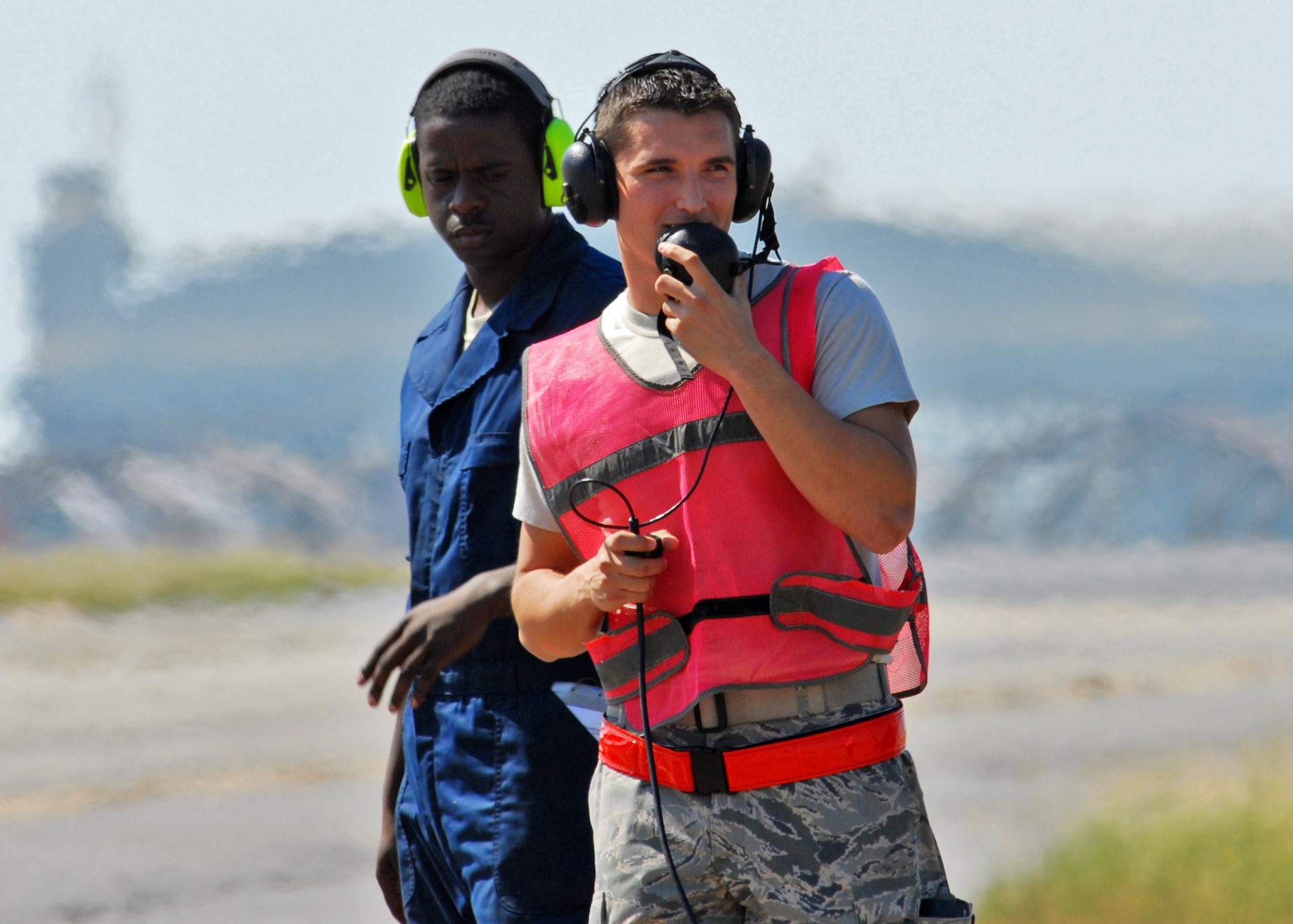 Senior Airmen Anthony Childers and Sanders Riddle, 46th Test Wing, stand on "the line" during end-of-runway duty at  Eglin Air Force Base, Fla.  More than 1,000 personnel of the 46th Maintenance Group are responsible for maintenance procedures for all of the 46th and 53rd aircraft located at Eglin.  (U.S. Air Force photo/Samuel King Jr.)  