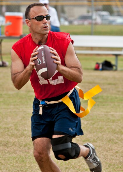 Col. Sal Nodjomian, 96th Air Base Wing commander, looks to pass downfield during the Chiefs vs Eagles flag football game Sept. 24 at Eglin Air Force Base, Fla.  The Chiefs crushed the Eagles 34-13.  Colonel Nodjomian played quarterback and scored a touchdown before an injury sidelined him.  (U.S. Air Force photo/Samuel King Jr.)