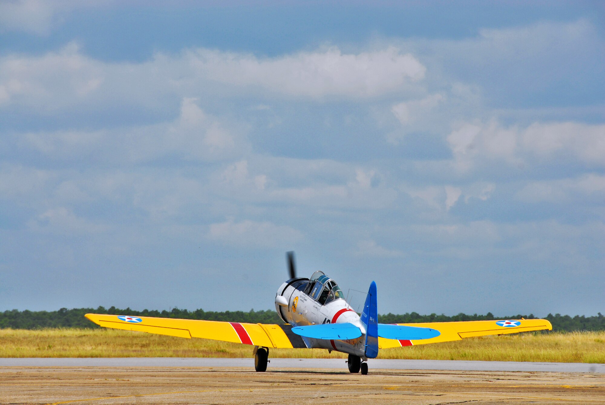 A T-6 taxis out another spouse for a flight Sept. 24 at Eglin Air Force Base, Fla., as part of the 85th's Spouse Taxi Day event.  Spouses were given tours and training before suiting up for a taxi ride in an F-16.  (U.S. Air Force photo/Samuel King Jr.)