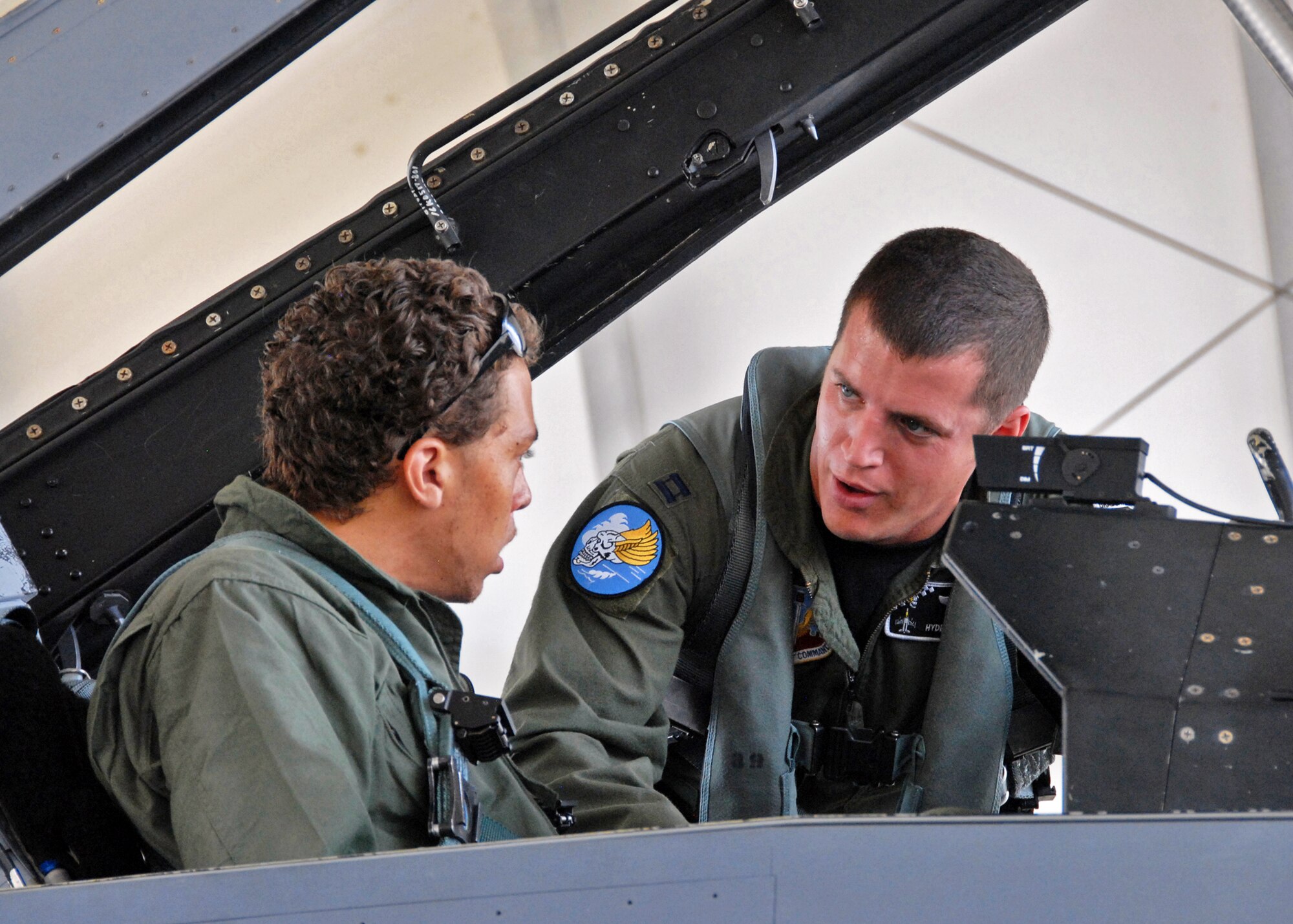 Capt. Sean Renbarger, 85th Test and Evaluation Squadron, briefs Benjamin Henry about the cockpit of the F-16 Fighting Falcon prior to taking him for a taxi ride Sept. 24 at Eglin Air Force Base, Fla.  The ride was part of the 85th's Spouse Taxi Day event.  Spouses were given tours and training before suiting up for a taxi ride in an F-16.  A few spouses received rides in a vintage T-6 courtesy of the 85th's honorary commander, Joe Fagundes.  (U.S. Air Force photo/Samuel King Jr.)