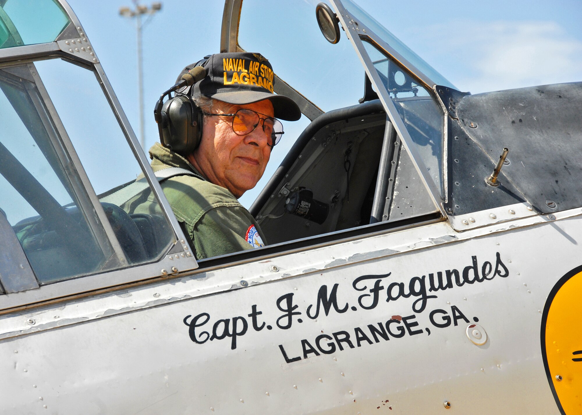 Joe Fagundes Sr. provided flights to spouses of the 85th Test and Evaluation Squadron in his vintage T-6 aircraft Sept. 24 at Eglin Air Force Base, Fla.  Joe Senior's, son Joe Fagundes III, is the honorary commander for the 85th.  The rides were part of the 85th's spouse taxi day event.  Spouses were given tours and training before suiting up for a taxi ride in an F-16.  (U.S. Air Force photo/Samuel King Jr.)