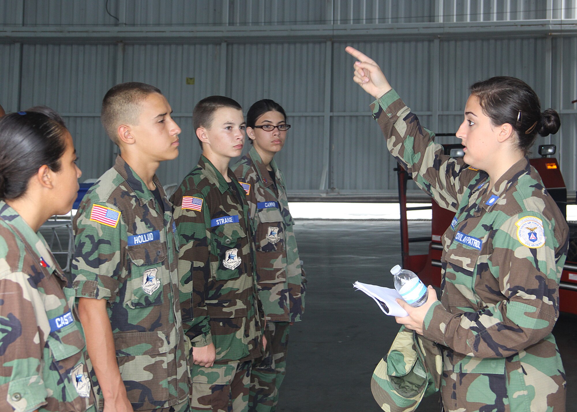 279th Civil Air Patrol Cadet Commander Karina Hamilton gives instruction to a group of cadets during a Young Eagles Flight event at Homestead General Aviation Airport; Sep. 25.The 279th C.A.P was in attendance to help out. Junior members of the unit were instructed on crowd control and aircraft marshaling. The 279th C.A.P. is based at Homestead Air Reserve Base. The C.A.P is the civilian auxiliary to the U.S. Air Force. (U.S. Air Force photo/ Ian Carrier)
