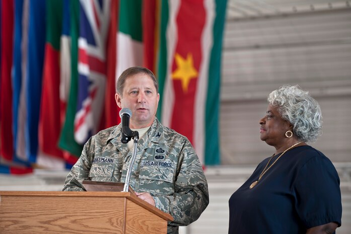 NELLIS AIR FORCE BASE, Nev.-- Col. Steven Winklmann, 99th Air Base Wing vice commander, presents a plaque to Irma Moore Sept. 25 honoring her husband, Elbert Moore, who passed away last year. The Retiree Activities office, where Mr. Moore volunteered for seven years, was renamed in his honor during the 2010 Retiree Appreciation Day. (U.S. Air Force photo by Lawrence Crespo)