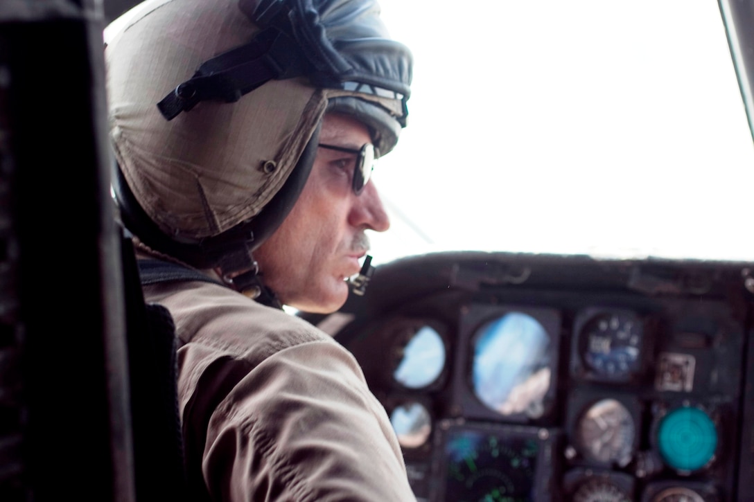 Col. Roy "Ozzie" Osborn, commanding officer of the 15th Marine Expeditionary Unit concentrates as he performs a difficult hover drop of relief supplies during humanitarian relief efforts in the southern province of Sindh, Pakistan.