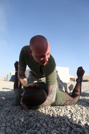 Sergeant Jared Lutz, 26, a black belt instructor with Headquarters Battalion, 1st Marine Division (Forward), grapples with Sgt. Christian Hutson, during a Marine Corps Martial Arts program Belt review at Camp Leatherneck, Afghanistan, Sept. 26. MCMAP is important because it instills discipline, and teaches Marines how to be well rounded in all aspects of warrior ethos and core values, said Lutz, from De Soto, Mo.