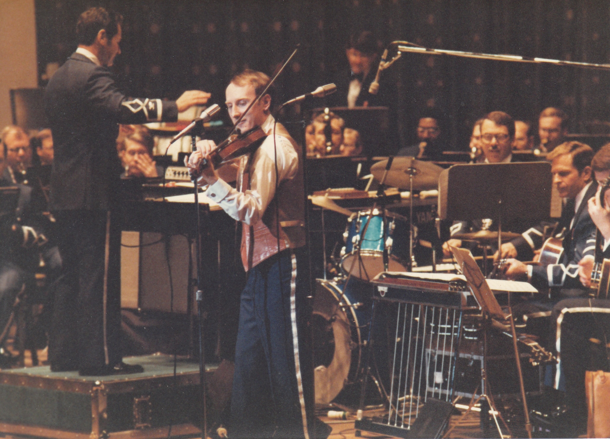 Chief Master Sgt. (Ret.) Jim Queen performs under the direction of Colonel (Ret.) Arnald Gabriel at the Daughers of the American Revolution Constitution Hall in Washington D.C. on February 22, 1981.  If you have any further insight regarding this photo, or any stories you can share about the event, please email our Band Historian <a href="mailto:usafbandhistorian@afncr.af.mil">Tech. Sgt. Tracey MacDonald</a>. Thank you and we look forward to hearing from you!  This is Photo 37. (Unknown Photographer)