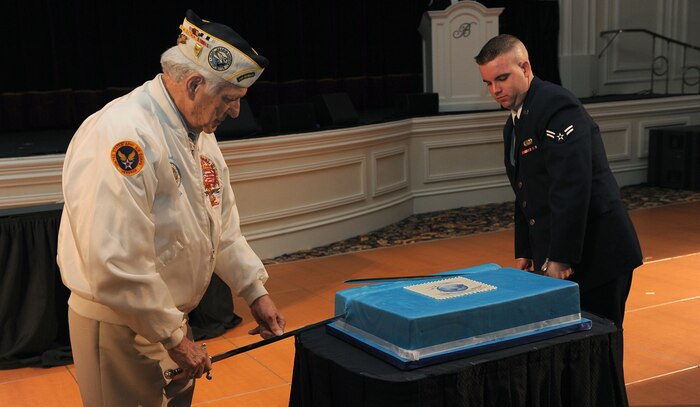 LAS VEGAS-- Edwin Hall, president of the Nevada Pearl Harbor Survivors Association, and Airman 1st Class John Wilson, 99th Logistics Readiness Squadron fuels apprentice, cut the cake during the 2010 Nellis-Creech Air Force Ball Sept. 25 at the Bellagio Resort and Casino. Mr. Hall and Airman Wilson represented the most senior and youngest Airman in attendance. (U.S Air Force Photo / Senior Airman Stephanie Rubi)