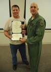 Tommy Reaves receives his certificate for 30 years of federal civilian service from  Col. Andy Comtois, 919th Special Operations Wing vice commander. The awards were presented at the 919th SOW’s civilian commander’s call Sept. 22. (U.S. Air Force photo/Staff Sgt. Jonathan McCallum)