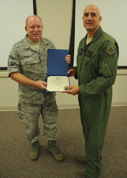 Senior Master Sgt. Steven Pannasch, left,  receives his certificate for 30 years of federal civilian service from  Col. Andy Comtois, 919th Special Operations Wing vice commander. The awards were presented at the 919th SOW’s civilian commander’s call Sept. 22. (U.S. Air Force photo/Staff Sgt. Jonathan McCallum)