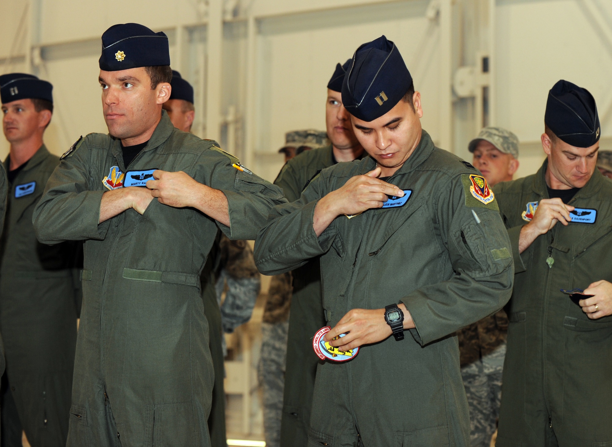 MOUNTAIN HOME AIR FORCE BASE, Idaho -- Members of the 390th Fighter Squadron change their patches to reflect the squadron re-designation to the 390th Electronic Combat Squadron during a ceremony in hangar 1331, Sept 27. The 390th ECS is responsible for training aircrews to operate the EA-6B Prowler, and started the transition to the E/F -18G Growler. (U.S. Air Force photo by Senior Airman Debbie Lockhart)
