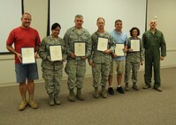 Displaying certificates honoring their 10 years of federal civilian service (from left) are: Bobby Cannon Jr.; Dalia Delannoy;  Master Sgt. Mark Harrell;  Senior Master Sgt. Mark Mioduszewski (accepting for Charles McBride); Michael Tomi; and Chief Master Sgt. Christine Cox (accepting for Bobby Turner).  With them is Col. Andy Comtois, 919th Special Operations Wing vice commander.  The awards were presented at the 919th SOW’s civilian commander’s call Sept. 22. (U.S. Air Force photo/Staff Sgt. Jonathan McCallum)