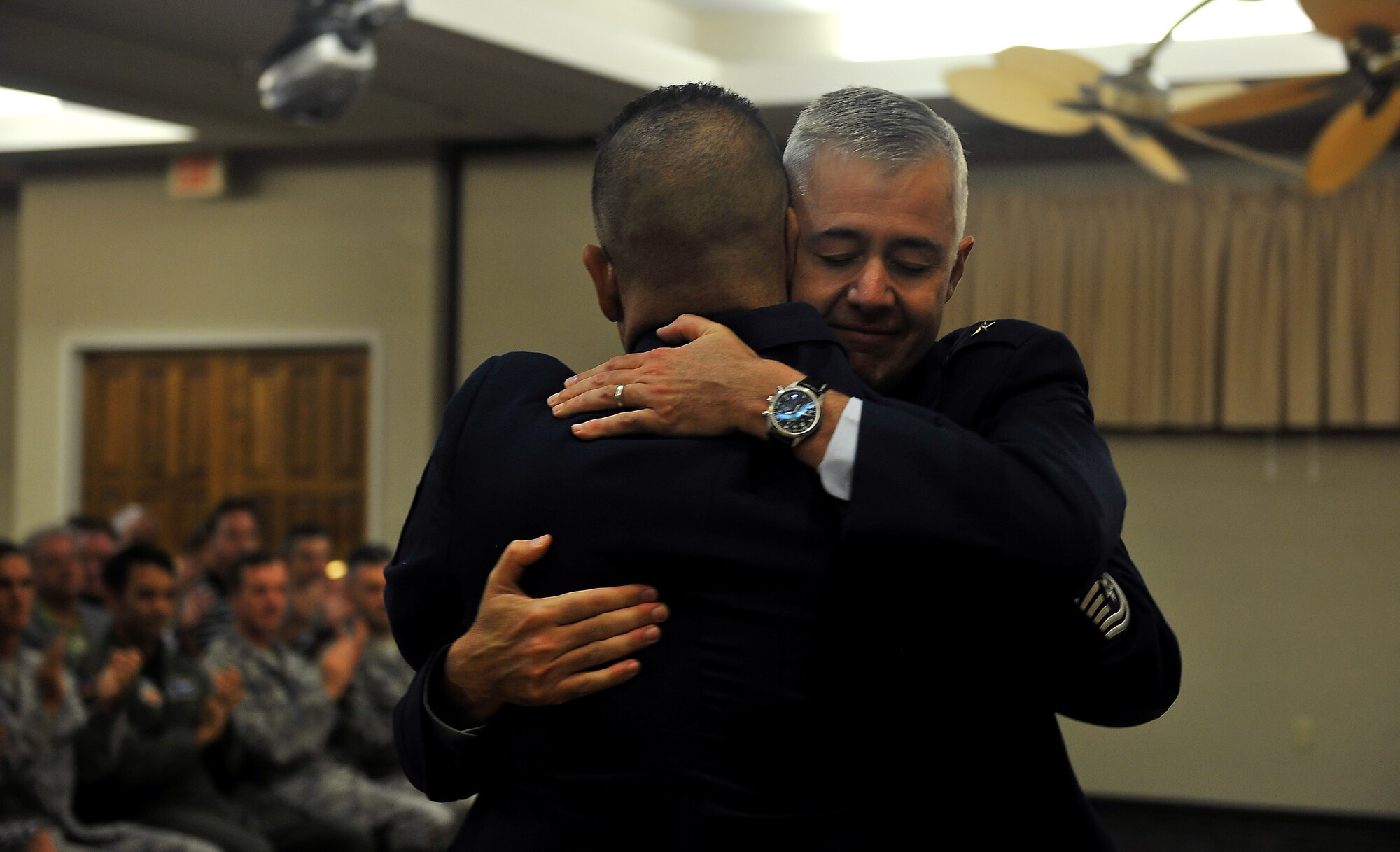 MOODY AIR FORCE BASE, Ga. -- Brig. Gen. Kenneth Todorov, Director, Standing Joint Force Headquarters, U.S. Northern Command, Peterson Air Force Base, Colo. and Chief Master Sergeant Paul Burgess, former Command Chief Master Sergeant, 332d Air Expeditionary Wing, Joint Base Balad, Iraq exchange hugs after General Todorov finishes his remarks about their career together here Sept. 10.  Chief Burgess said he chose General Todorov to officiate his retirement ceremony not only because of their professional relationship but because they have been close friends for more than 22 years and “it just made sense.” (U.S. Air Force photo/Airman 1st Class Joshua Green)
