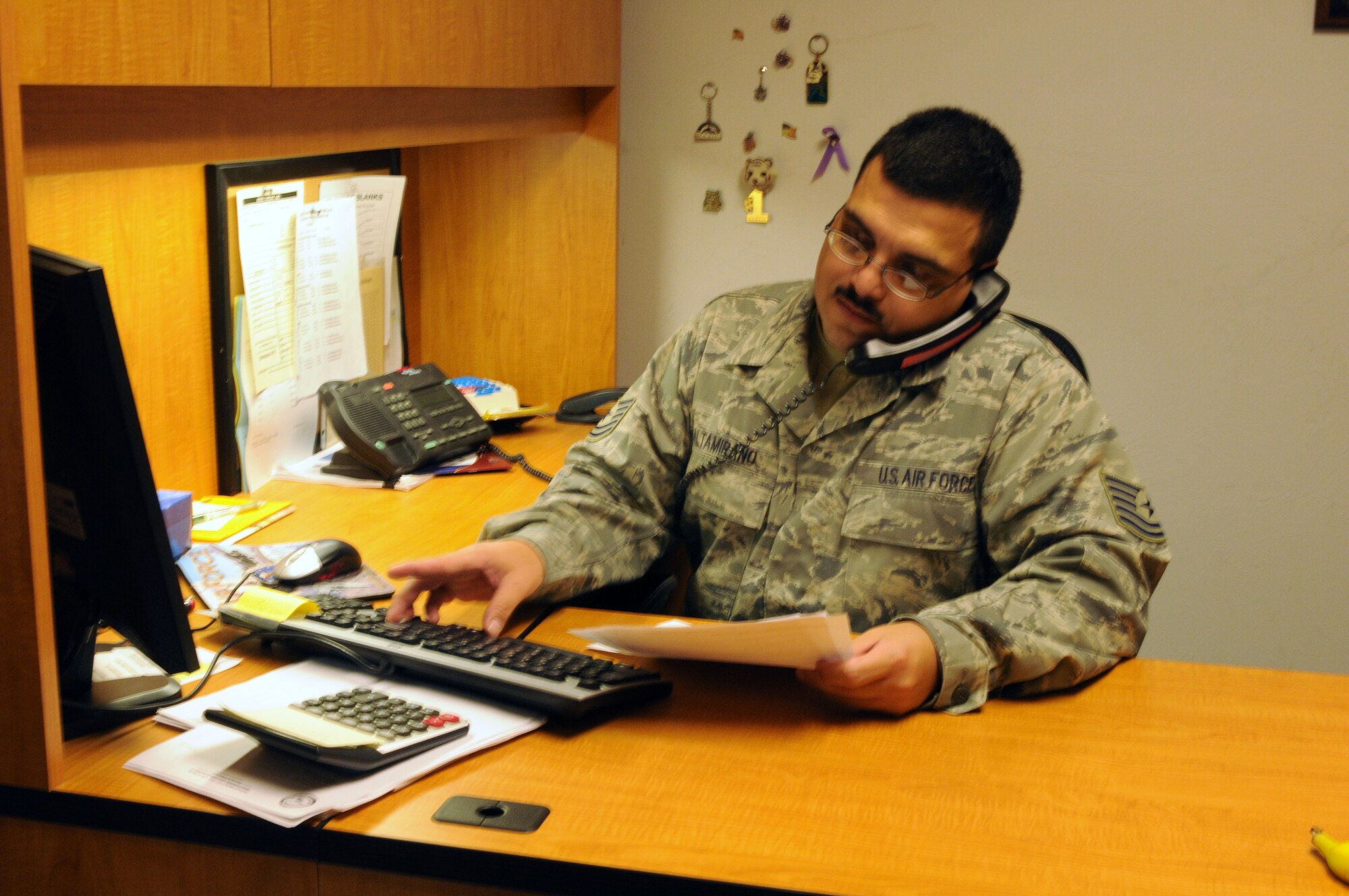 Tech. Sgt. Martin Altamirano, budget technician, works with Tech. Sgt. Jorge Sosa, resource advisor for logistics readiness squadron, over the phone Aug. 27 to balance LRS’s government purchase card (GPC) account. Balancing more than 15 GPC accounts for the 162nd Fighter Wing is only one small aspect of what it takes to balance the entire wing budget. (Air Force photo by Staff Sgt. Jordan Jones)