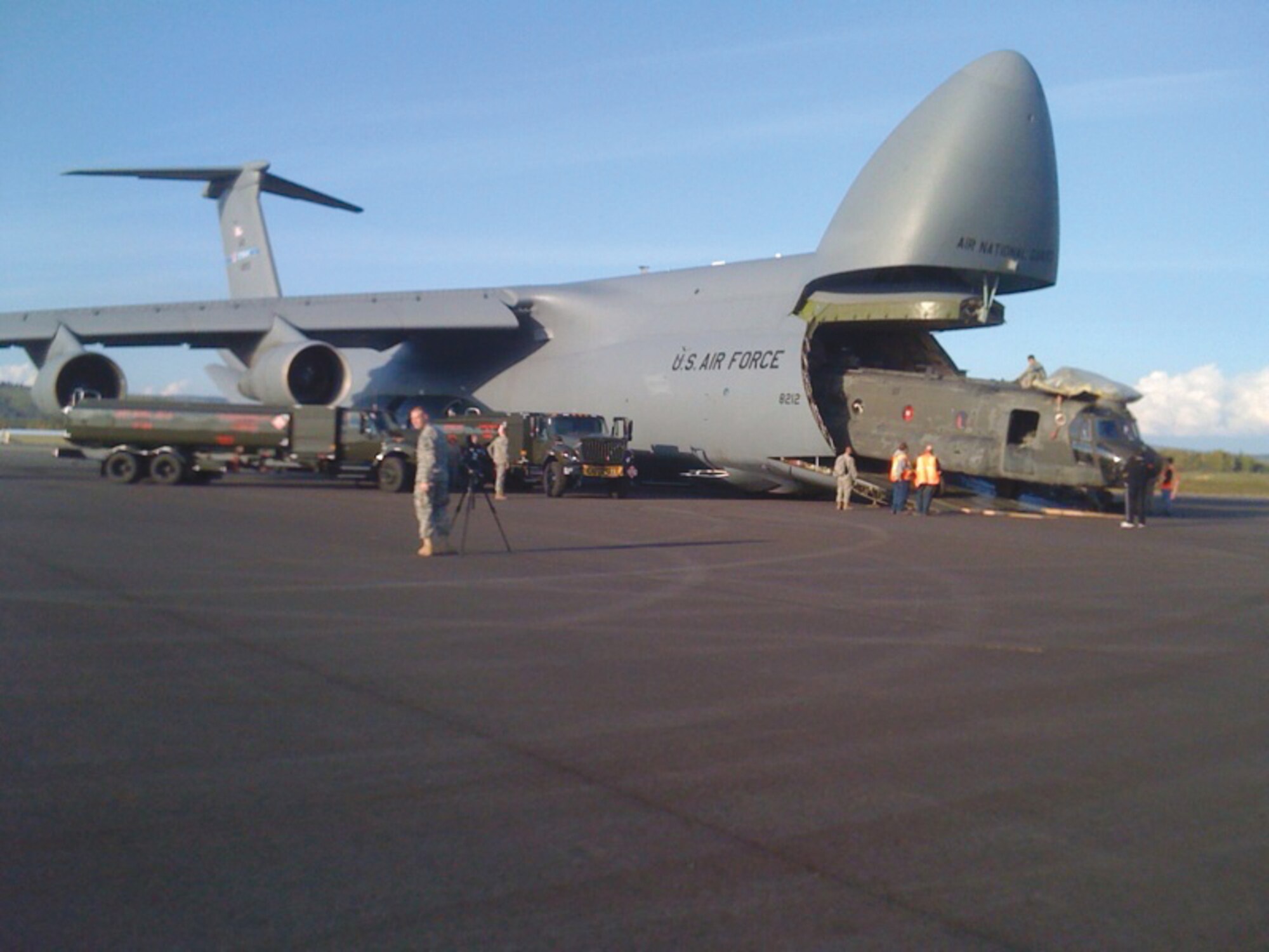 A CH-47 Chinook helicopter and personnel are loaded onto a C-5 Galaxy aircraft at Fort Wainwright. The Army helicopters were flown to Pakistan by the Air Force, where they went to work in the humanitarian aid mission, which to date had delivered more than 8 million pounds of supplies to several million Pakistanis displaced by flooding of the Indus River. (Courtesy photo)