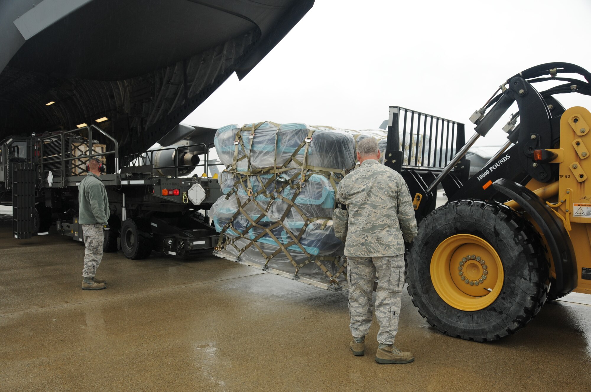 STEWART AIR NATIONAL GUARD BASE - A Dover AFB C-17 crew delivers refurbished materials and equipment to airmen of the 105th Logistics Readiness Squadron here Sept. 27, 2010. The delivery is for aircraft maintainers of the 105th Airlift Wing and other supporting units to do their part in the final reconditioning of the first C-5M.  This Total Force effort plans to standardize and recondition the entire C-5 fleet. (U.S. Air Force Photo by Tech. Sgt. Michael O'Halloran)
