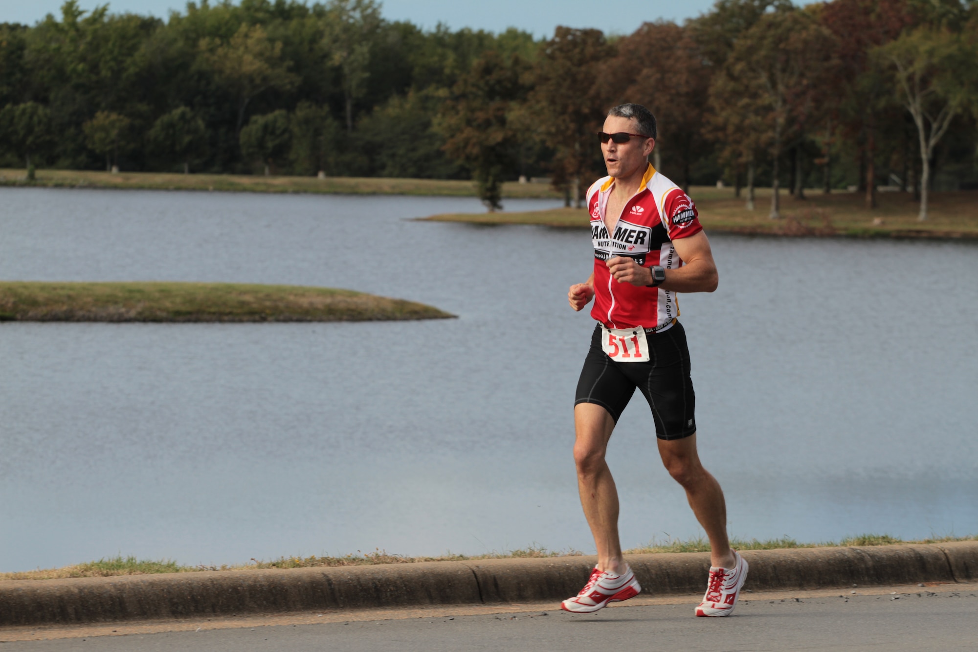 Lt. Col. Jonathan Steckbeck, 62nd Airlift Squadron, runs past the base lakes Sept. 25 toward the finish line at Hangar 1080 during the ‘Round the Rock Adventure Race. Colonel Steckbeck came in first place with a time of 1:12:33 for his kayaking, biking and running. (U.S. Army photo by Spc. Jared Sollars)