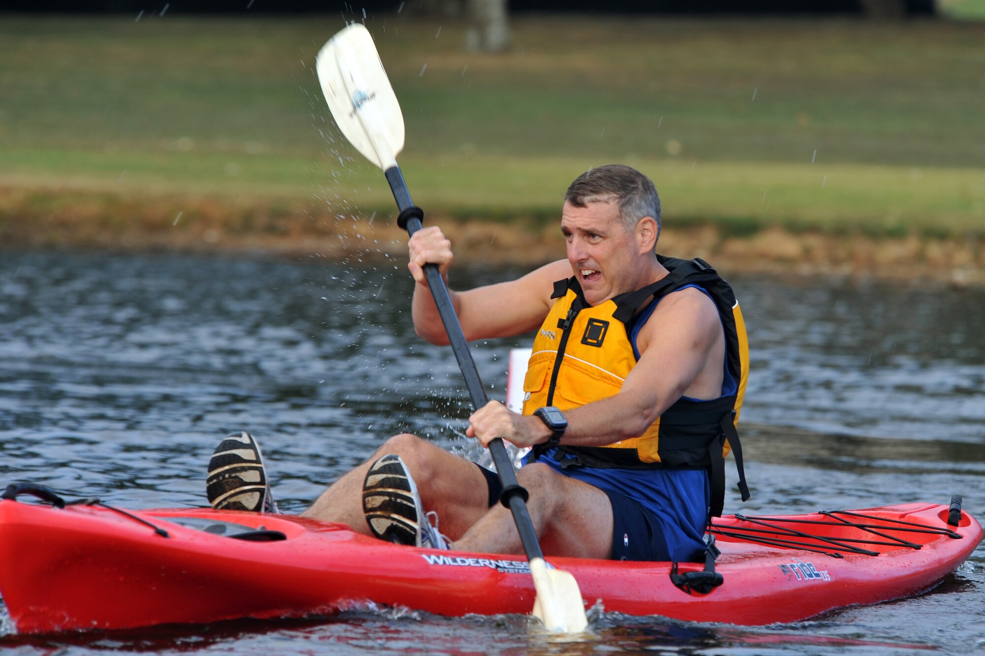 Col. Mike Minihan, 19th Airlift Wing commander, powers his way through the water around the base lake on a kayak Sept. 25.  Several members from Team Little Rock participated in the ‘Round the Rock Adventure Race that combined kayaking around the big base lake, a 14.1-mile bike-trail course and a 5-kilometer run, ending at Hanger 1080. (U.S. Air Force photo by Staff Sgt. Chris Willis)