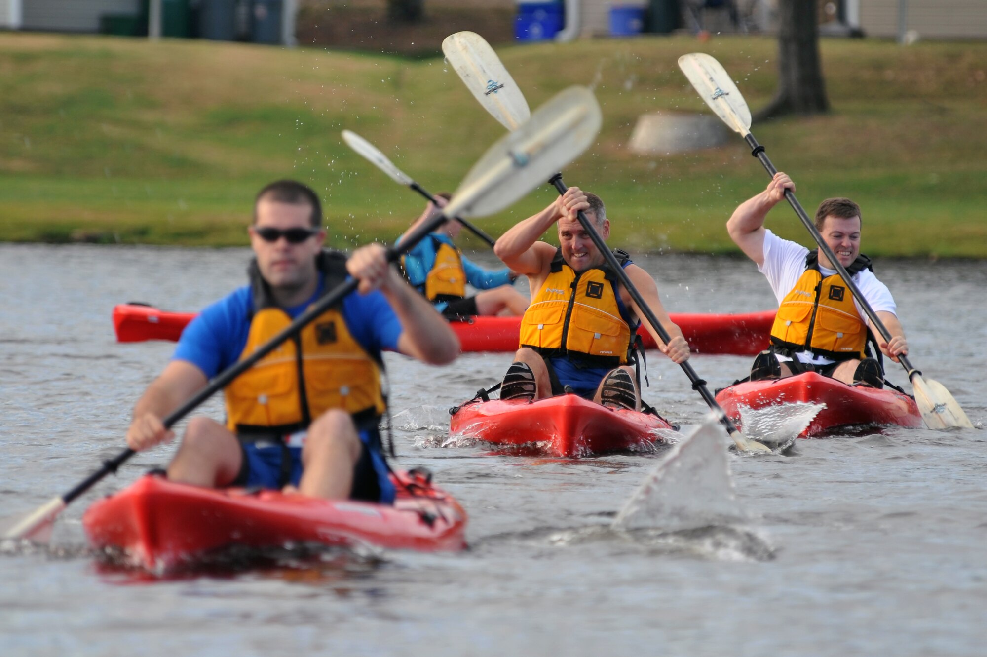 A group of competitors paddle their way through the first portion of the ‘Round the Rock Adventure Race Sept. 25.  Several members from Team Little Rock participated in the event that combined kayaking around the big base lake, a 14.1-mile bike-trail course and a 5-kilometer run, ending at Hanger 1080. (U.S. Air Force photo by Staff Sgt. Chris Willis)