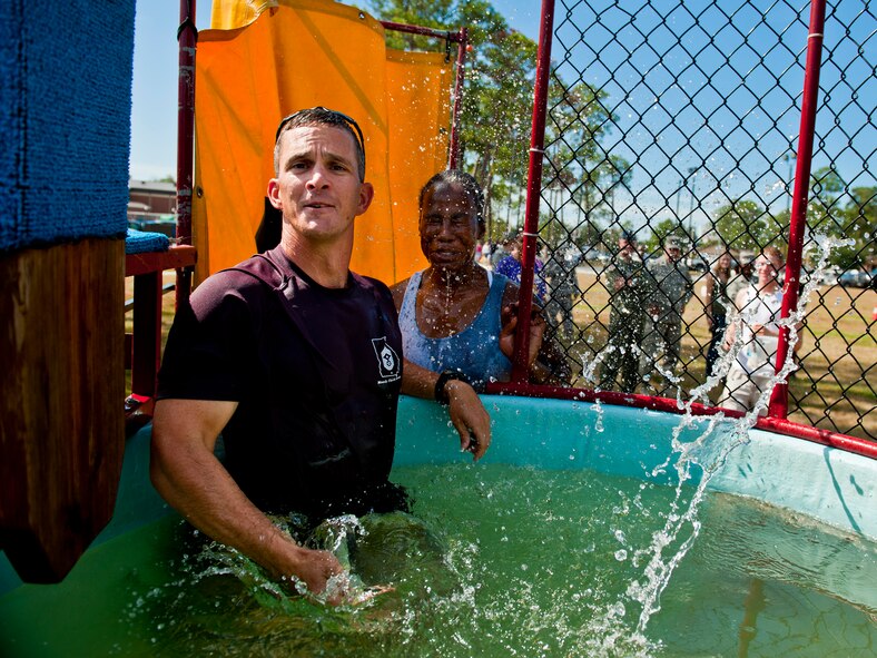 MOODY AIR FORCE BASE, Ga. -- Chief Master Sgt. Richard Parsons, 23rd Wing command chief, splashes water on Airman 1st Class Altanee Manor, 822nd Security Forces Squadron fire-team member, after she successfully dunks him in a water booth during Airman Appreciation Day Sept. 24. The day provided Airmen a chance to get away from their work centers, relax and spend time with family and friends. (U.S. Air Force photo/Senior Airman Jamal D. Sutter)