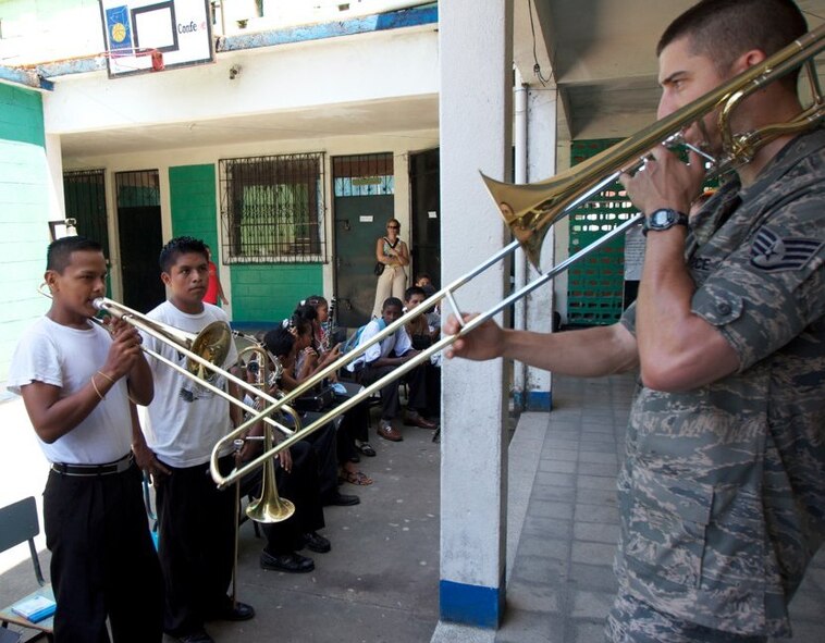 Staff Sgt. Doug Kost, New Harmony ensemble member, leads a student during a workshop in Livingston, Guatemala. The United States Air Force Band of Flight’s deployed ensemble, New Harmony, reached the midpoint of its deployment to the Caribbean and Latin America in support of the Navy's Operation Continuing Promise. (U.S. Air Force photo/Maj. R. Michael Mench)

