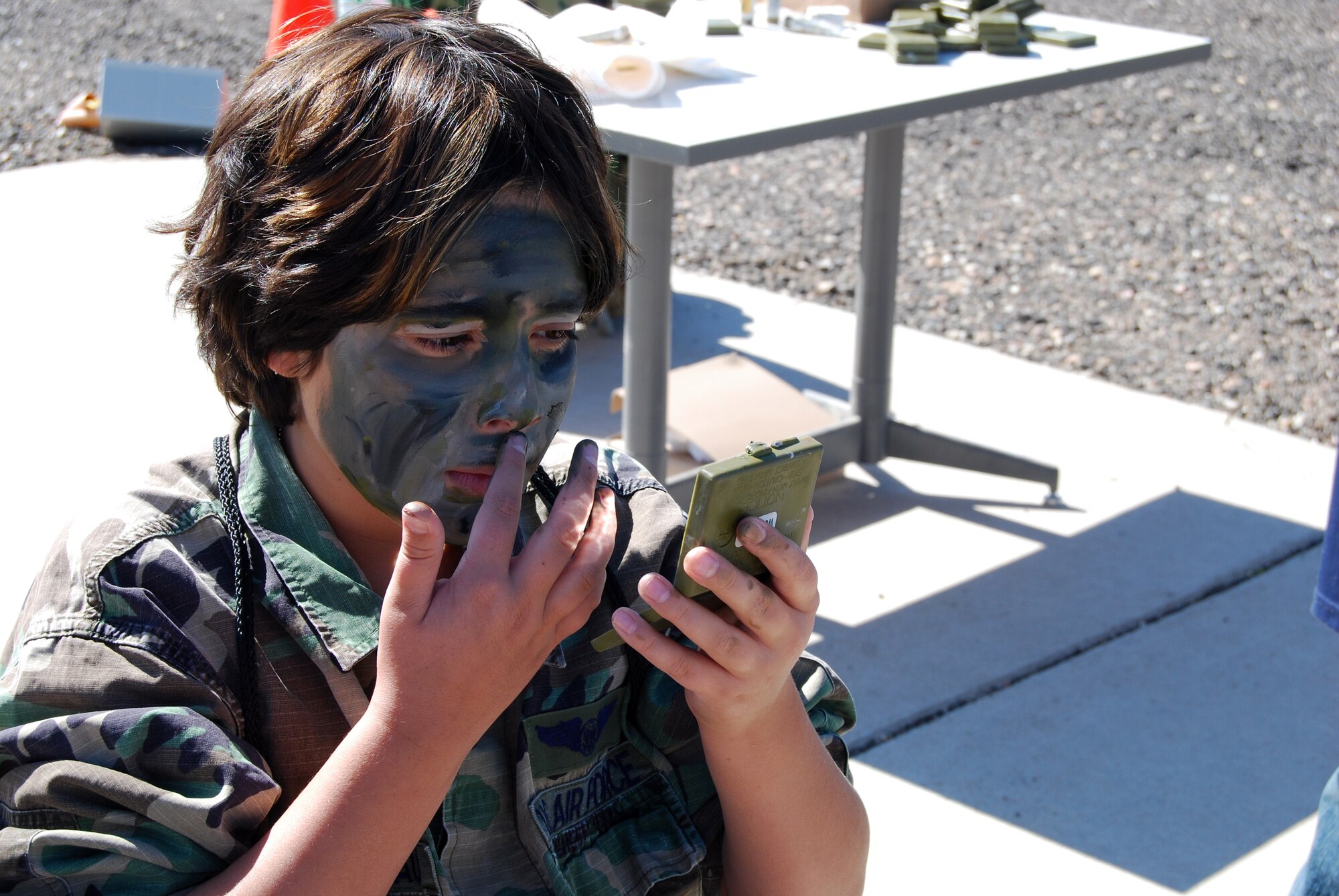 Christopher Thibodeau, son of Josie and Master Sgt. (ret.) Chris Thibodeau, applies camouflage during the Youth Mock Deployment last year. This year the event is called the Family Mock Deployment and will take place Oct. 2 at 8 a.m. For questions or to register, contact the Airmen Family Readiness Center at 847-6681. (Courtesy photo submitted by Mary Monzon.)