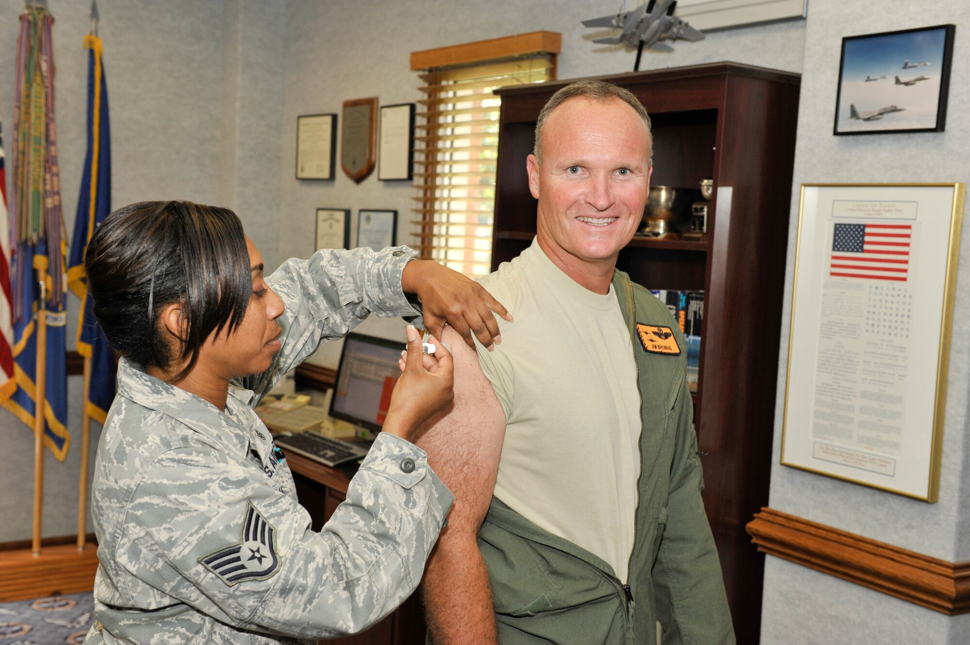 Staff Sgt. Audra Hamilton, 325th Aerospace Medicine Squadron medical technician, gives Brigadier Gen. James Browne, 325th Fighter Wing commander, his annual flu shot Sept. 21.  The general was among the first group of active duty military to receive the vaccination.  This year the vaccine is a combined product that includes the seasonal and H1N1 strains.  As in previous years, medical group officials will schedule flu shot locations around base as the flu vaccine becomes available.  For more information, call the immunization clinic at (850) 283-7570. (U.S. Air Force photo by Jonathan Gibson)
