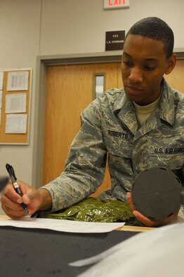 ELLSWORTH AFB, S.D. – Airman 1st Class Stephen Roberts, 28th Operations Support Squadron aircrew flight equipment technician, inventories a canister from a D-1 aircrew chemical defense equipment bag, Sept. 23. Airman Roberts conducted the inventory as part of an annual inspection. (U.S. Air Force photo/Senior Airman Kasey Close)