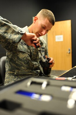 ELLSWORTH AFB, S.D. – Senior Airman Eric Schneider, 28th Operations Support Squadron aircrew flight equipment technician, repairs night-vision goggles for a B-1B Lancer pilot, Sept. 23. Airman Schneider repaired the goggles as part of a standard 180-day inspection. (U.S. Air Force photo/Senior Airman Kasey Close)