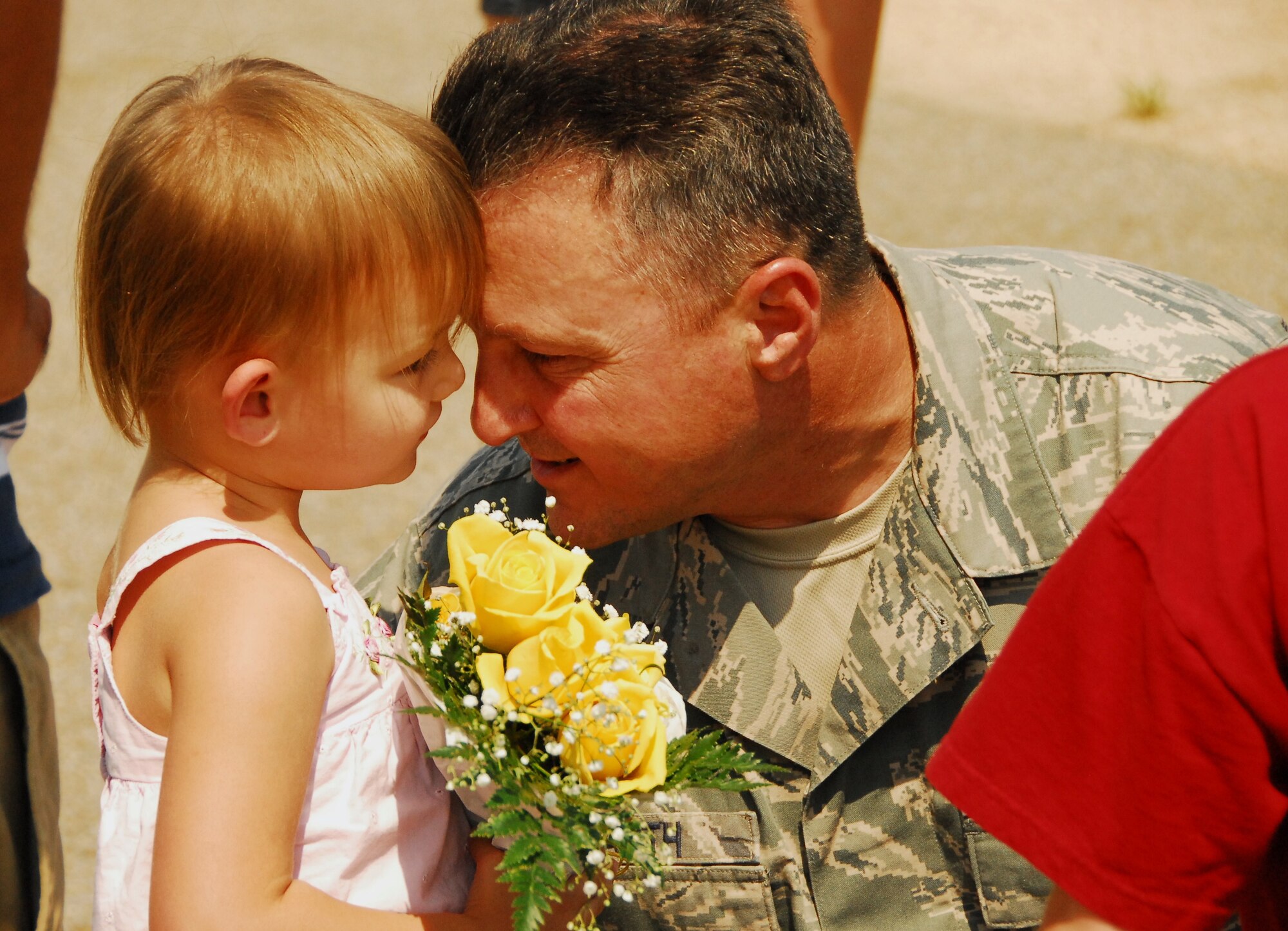 Chief Master Sgt. Doug Dearth greets his granddaughter, Lainey, after his return to Maxwell AFB. Approximately 150 members of the 908th Airlift Wing recently returned from a four-month deployment to Southwest Asia. (Air Force photo by Gene H, Hughes)